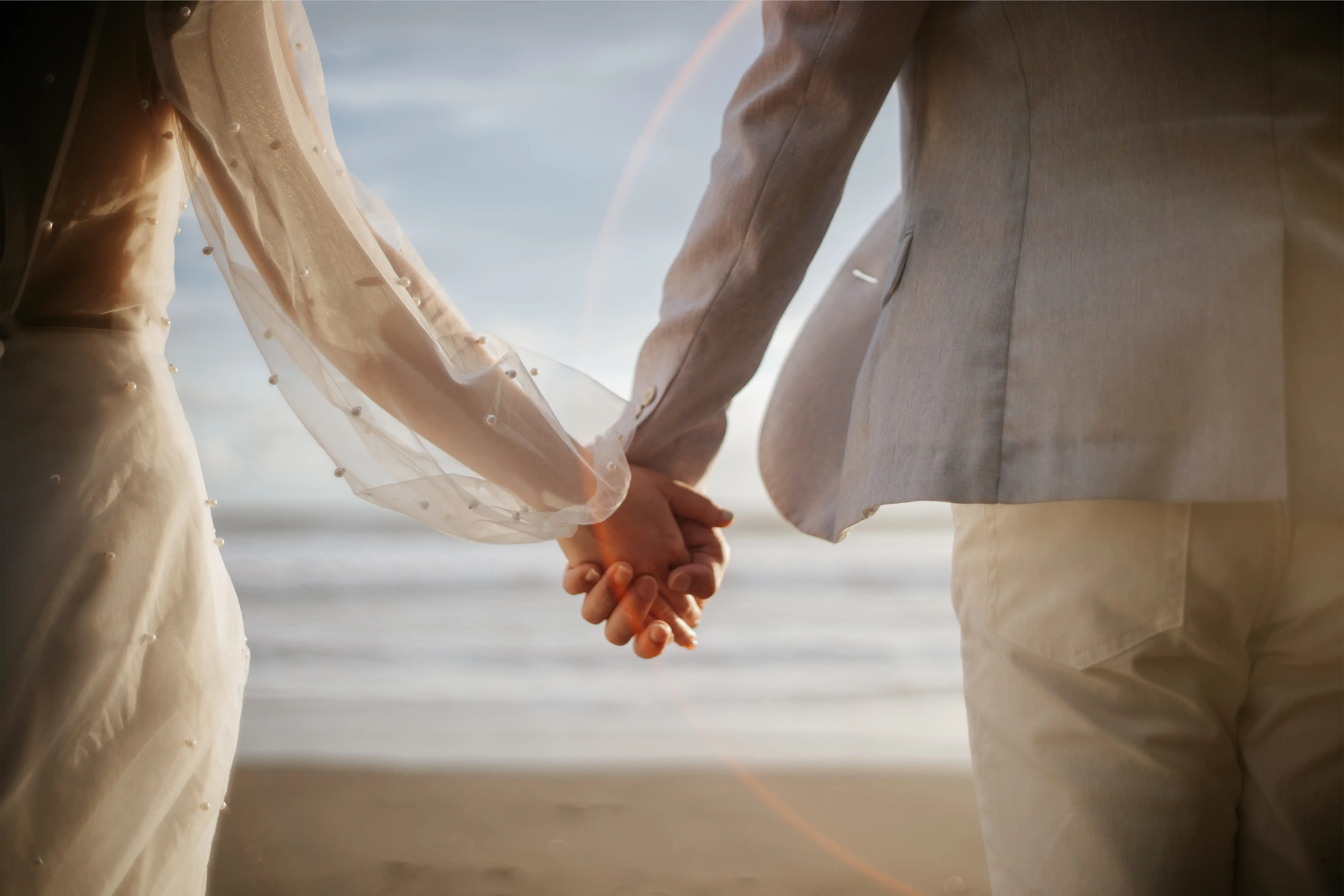 Photo of groom and bride holding hands