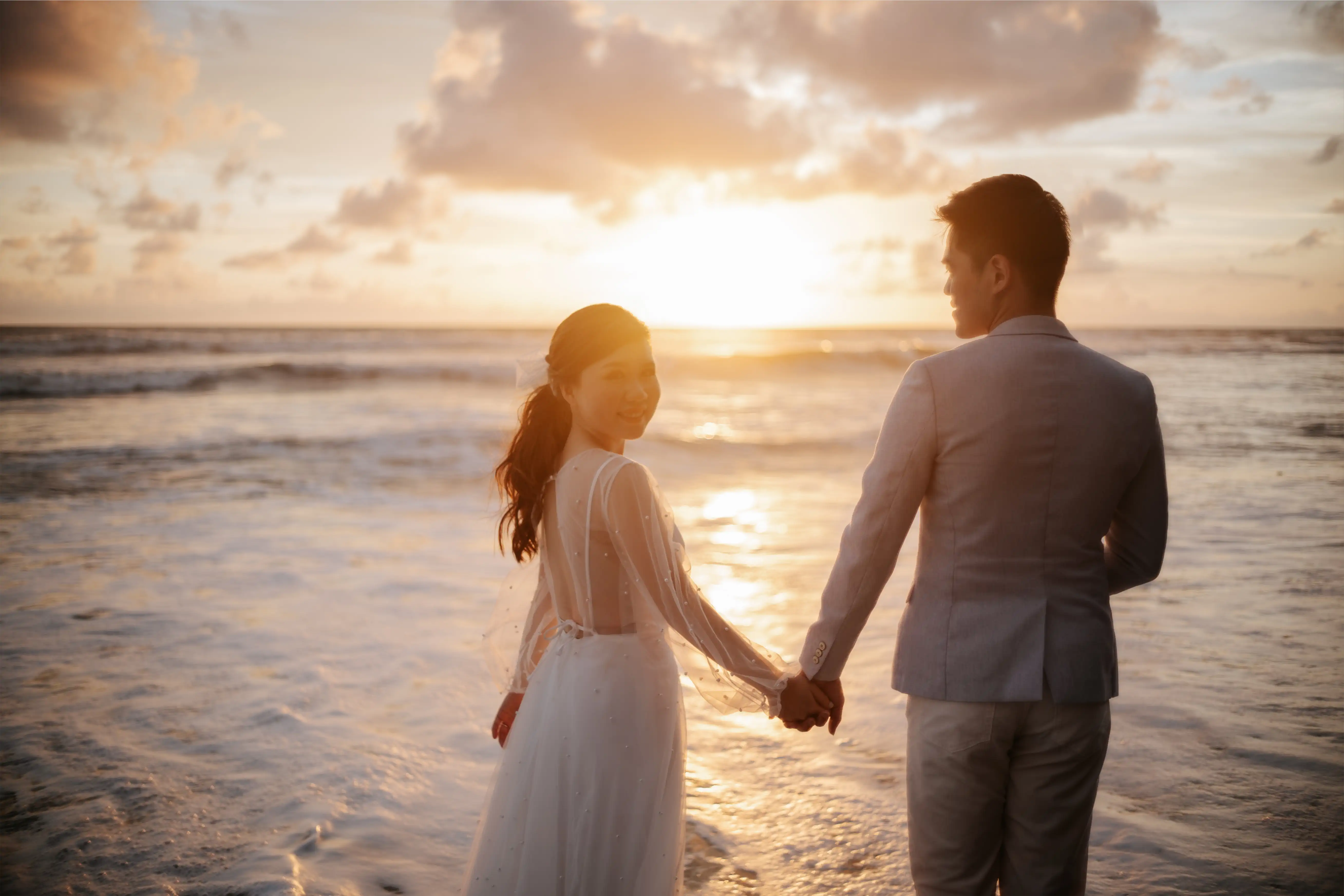 Photo of groom and bride at the beach